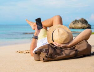 man on beach with phone