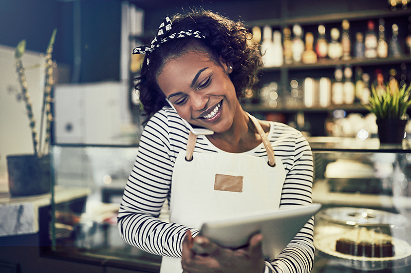 Smiling,Young,African,Entrepreneur,Standing,At,The,Counter,Of,Her
