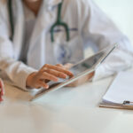 Shot of a doctor showing a patient some information on a digital tablet